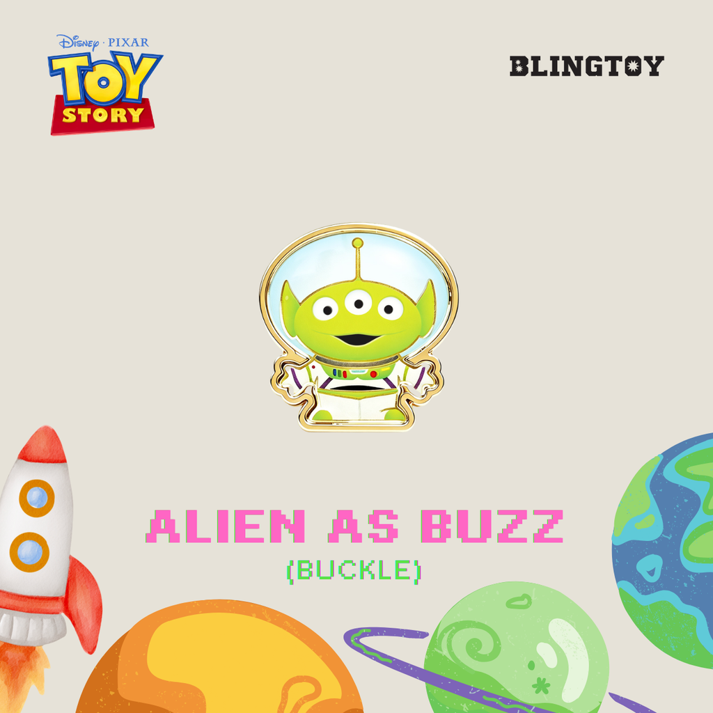 Disney Pixar Toy Story Alien as Buzz buckle pin on a light beige background with Toy Story branding, the word BLINGTOY, and space-themed illustrations including a rocket, planets, and the text 'ALIEN AS BUZZ (BUCKLE)'.