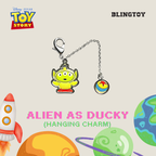 A Disney Pixar Toy Story Alien as Ducky hanging charm keychain, featuring a yellow-green alien charm with red pants and a small round charm with a yellow sun and blue cloud, on a beige background with Toy Story and Blingtoy branding.