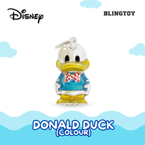 A Donald Duck charm pendant by Blingtoy, featuring a silver-tone metal base with turquoise blue enamel, yellow beak and legs, and a red bow tie with white polka dots. The image includes Disney branding at the top left and Blingtoy branding at the top right, with a light blue and white graphic design at the bottom.