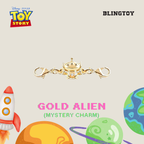 A gold-plated Alien charm keychain with two lobster clasps, displayed on a light beige background with Disney Pixar Toy Story branding, 'BLINGTOY' text, and colorful cartoon planets and a rocket.