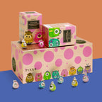 Pixar Toy Story mosters inc blind box set with multiple colorful character figures displayed on and around the boxes against a two-tone orange and blue background.