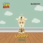 A gold-plated Woody character pendant from Disney Pixar Toy Story, displayed against a stylized background featuring a light green sky with white clouds and a brown wooden floor. The image includes 'Disney Pixar Toy Story' branding in the top left, 'BLINGTOY' in the top right, and 'WOODY (GOLD)' text at the bottom.